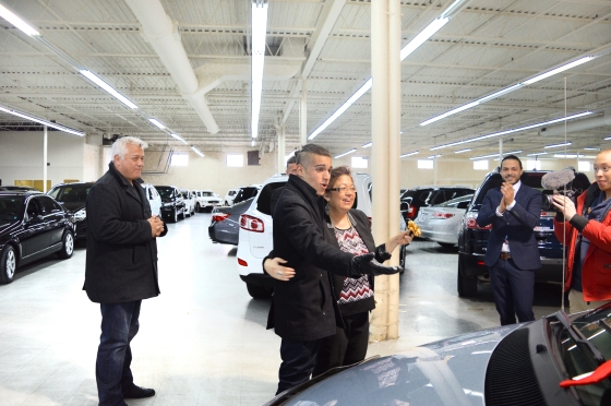 happy son embraces mother after getting free car from autorama