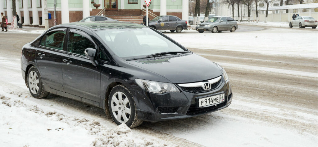honda civic parked on snowy street
