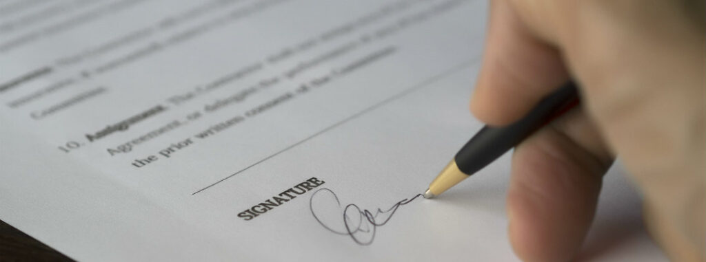 signing a piece of legal paper for car application